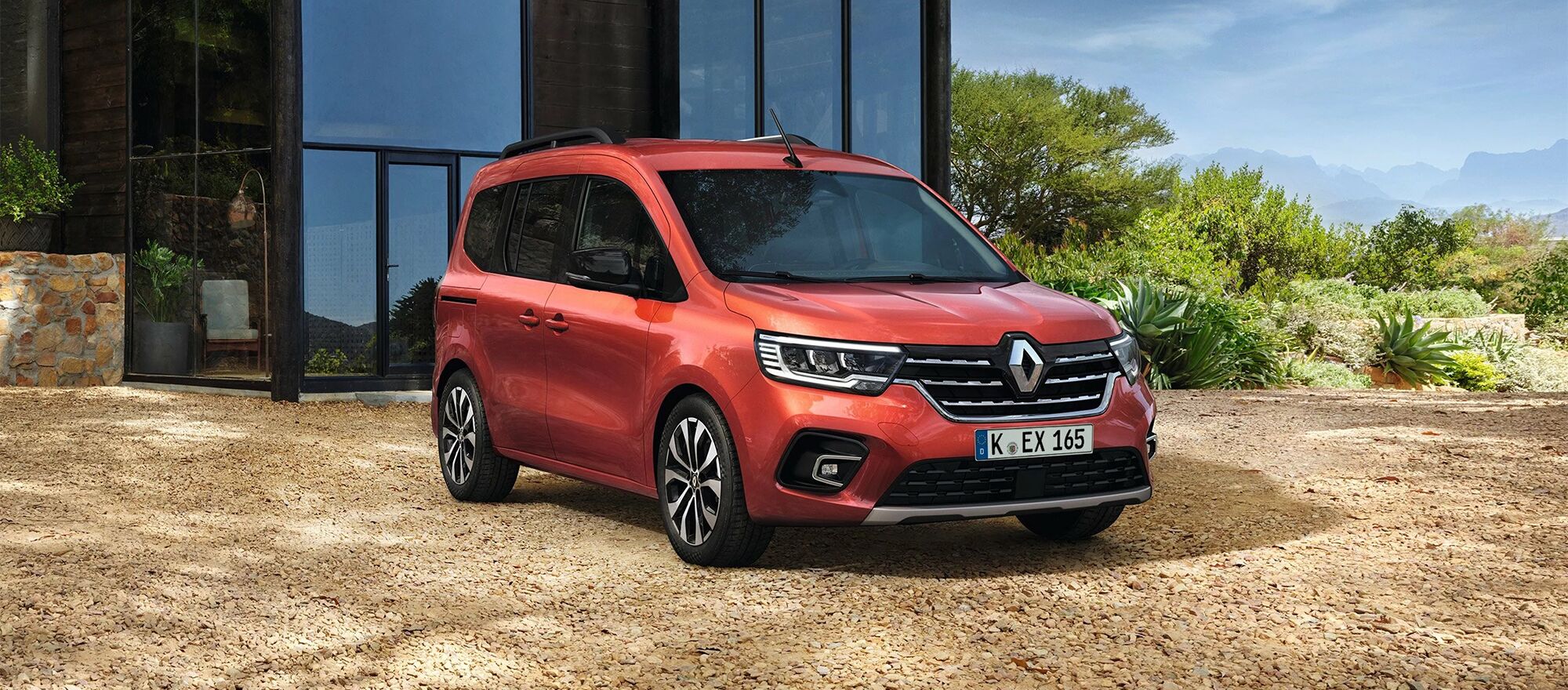 Der Renault Kangoo parkt direkt vor einem Glashaus